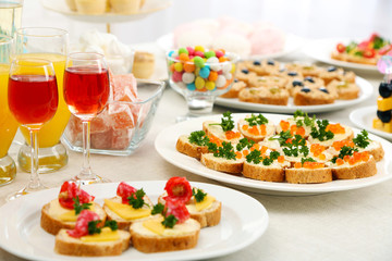Set of cold snacks, canape, beverages, closeup