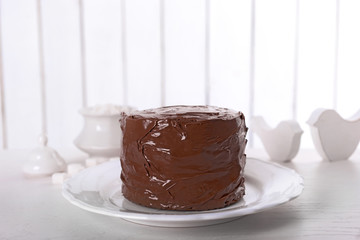 Tasty chocolate cake on light background