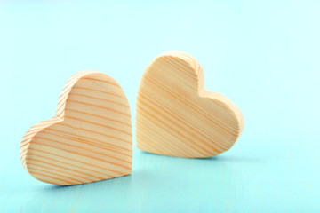 Wooden hearts on color wooden background