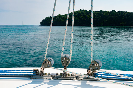 Small winch with rope on the deck of luxury yacht