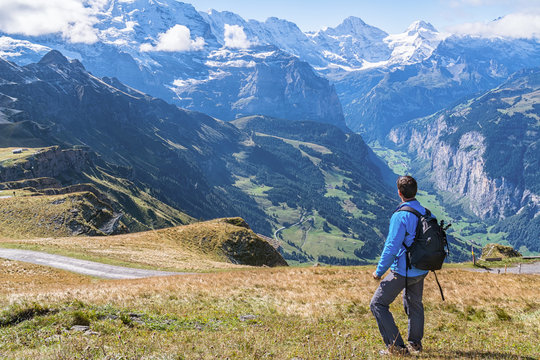 Hiker enjoying the spectacular view in the heart of Swiss alps