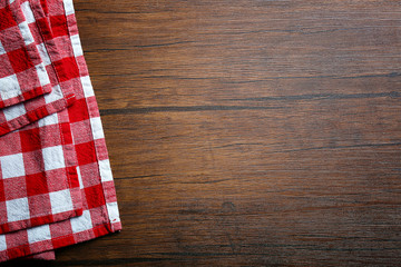 Fototapeta na wymiar Checkered napkin on wooden background