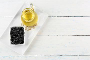 Sunflower seeds with oil on wooden table