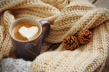 Cup of coffee with marshmallow on wooden table