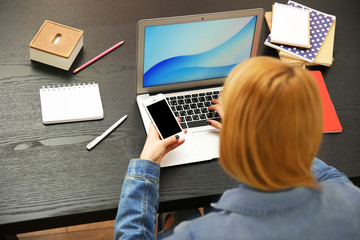 Woman working on a laptop at office desk