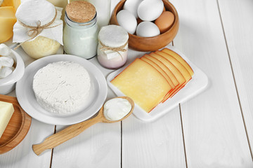 Set of fresh dairy products on white wooden table
