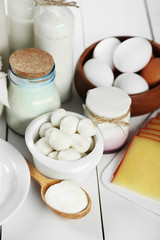 Set of fresh dairy products on white wooden table
