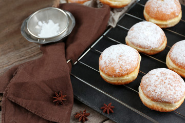 Fresh homemade donuts with powdered sugar, close up
