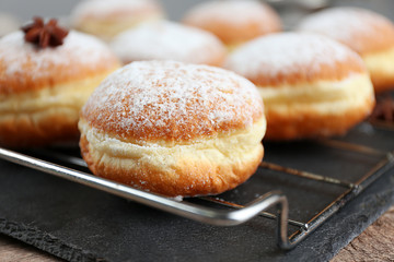 Fresh homemade donuts with powdered sugar, close up