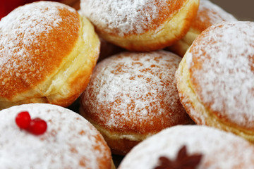 Fresh homemade donuts with powdered sugar, close up