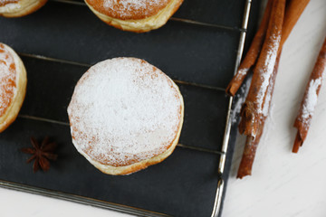 Fresh homemade donuts with powdered sugar, close up