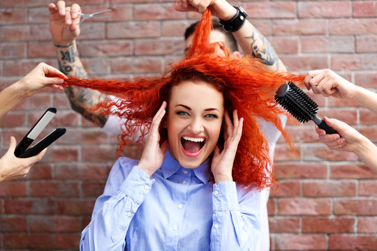 Red haired beautiful girl with many hands and accessories