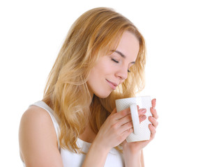 Beautiful girl enjoying a cup of tea, isolated on white