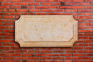 a signboard marble on brick wall.