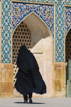 Muslim woman with traditional chador on the street