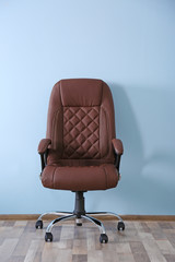 New office chair on wall background
