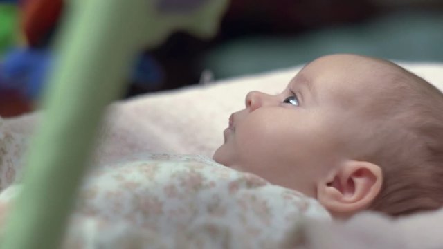 Newborn Looking At Colorful Baby Toy 
