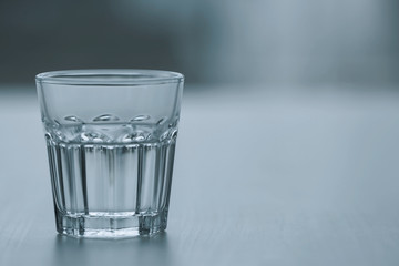 Glass of pure water on blurred background