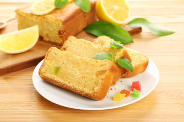 Pieces of delicious citrus cake on wooden table