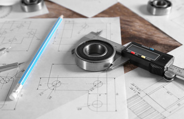 Set of engineering drawings with tools on wooden background