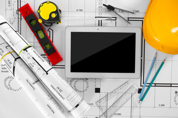 Construction blueprints with tools and tablet, top view