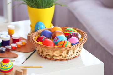 Easter eggs with paints on wooden table, indoors