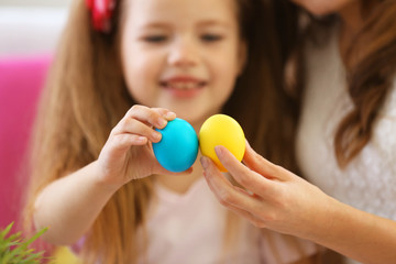 Fototapeta na wymiar Mother and daughter holding Easter eggs closeup