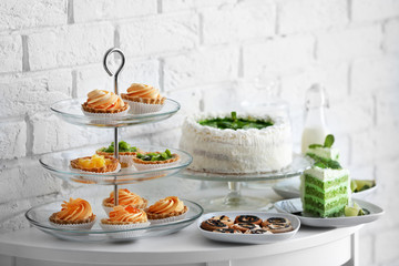 Different delicious desserts on table