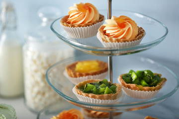 Delicious desserts  on a glass stand