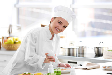 Female chef working at kitchen