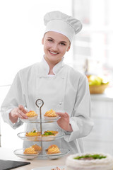Female chef working at kitchen