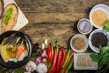 Salmon grilled fish, rice dishes with vegetables and spices in c
