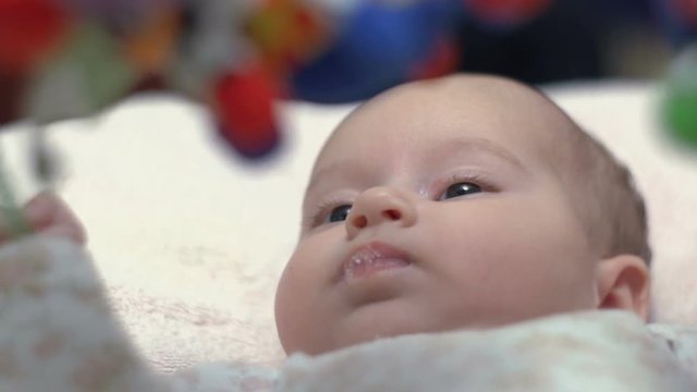Newborn Looking At Colorful Baby Toy