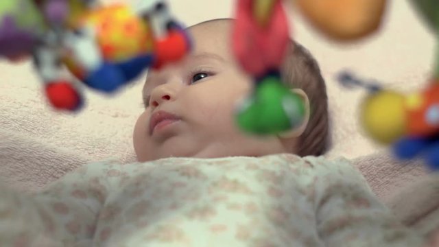 Newborn Looking At Colorful Baby Toy
