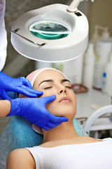 Young woman having face massage in a beauty salon