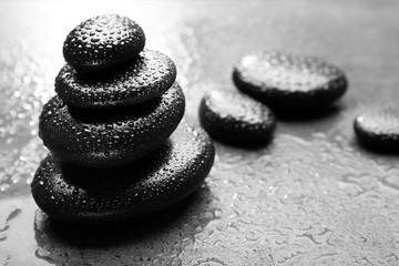 Stack of spa hot stones  on grey background