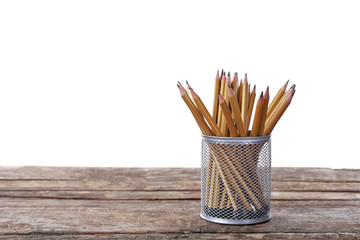 Pencils in metal holder on white background