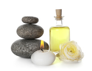 Fototapeta na wymiar Spa still life with pebbles, oil and candle isolated on white