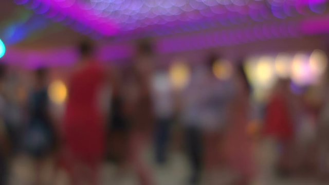 Young unrecognizable people enjoying themselves at the night club 