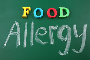 Text FOOD ALLERGY on blackboard background