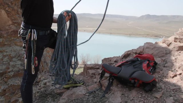 Climber carrying a rope and gear