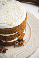 Cake with cream on the white wooden background. Shallow depth of field.