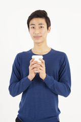 portrait of young handsome man holding cup of coffee 