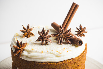 Cake with cream on the white wooden background. Shallow depth of field.