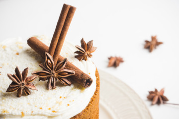 Cake with cream on the white wooden background. Shallow depth of field.