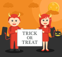  men and women dressed as devil holding a sign trick or treat