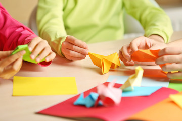 Children making swan with coloured paper