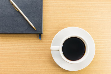 Coffee cup and notebook