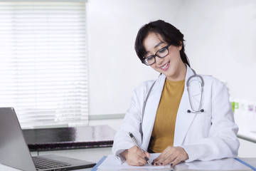 Female doctor working in the clinic room