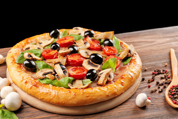 Delicious tasty pizza with ingredients on wooden table